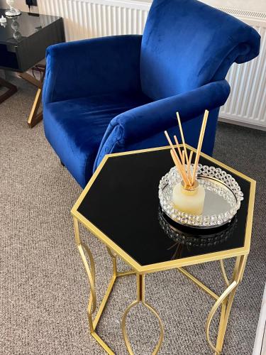 a blue couch and a coffee table in a living room at VIP Villa & Spa in Colibiţa