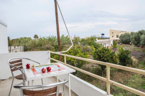 a balcony with a table with fruit on it at Sunny Apartments - ex Zoi Studios in Agioi Apostoli