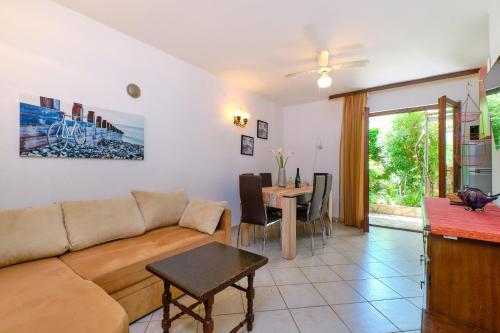 a living room with a couch and a table at Apartments Marija in Mali Lošinj