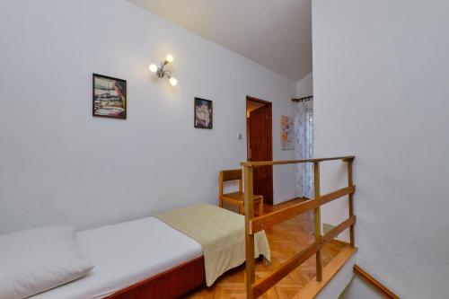 a bedroom with a bunk bed and a staircase at Apartments Marija in Mali Lošinj