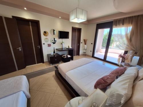 a bedroom with a large bed and a large window at Villa Maria in Haraki