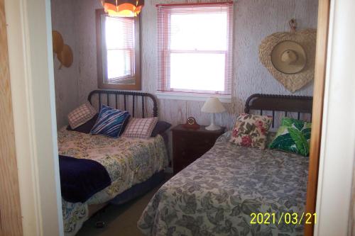 1 dormitorio con 2 camas y ventana en C-Scape, en Boutiliers Point
