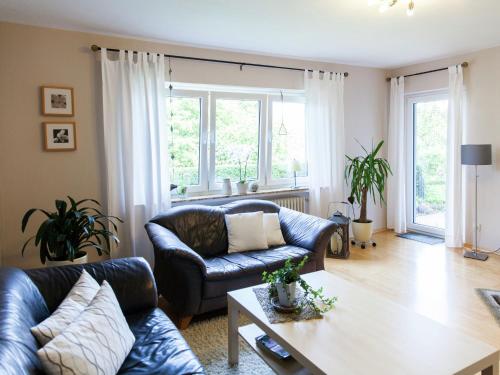 a living room with a couch and a table at Apartment in Niederehe near the forest in Üxheim