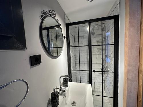 a bathroom with a sink and a mirror at Likya Garden Life in Gâvurağılı