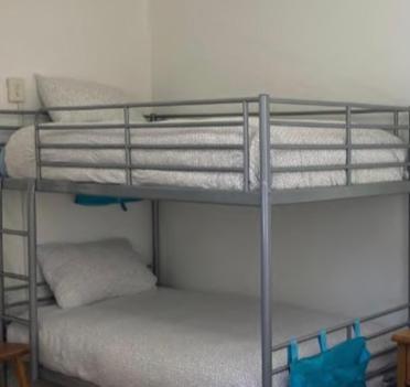 a bunk bed with four bunk beds in a room at FLiXBEDS - Airport Hostel Book Now! Under New Management in Fort Lauderdale