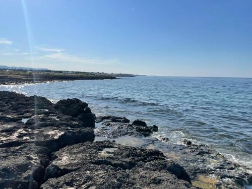 a group of rocks on the shore of the ocean at Casa in stile in Pezze di Greco