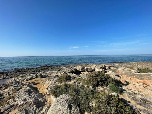 a view of the ocean from a rocky beach at Casa in stile in Pezze di Greco