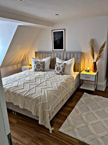 a bedroom with a large bed with two night stands at Ferienwohnung Grüne Straße 1 in Wernigerode
