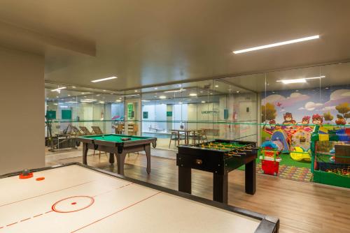 a childrens play room with two pool tables at Hotel Laghetto Fratello in Gramado