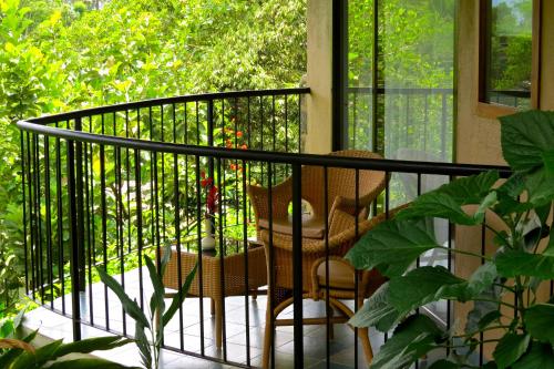 a balcony with a rocking chair on a porch at Poetree Thekkady in Thekkady