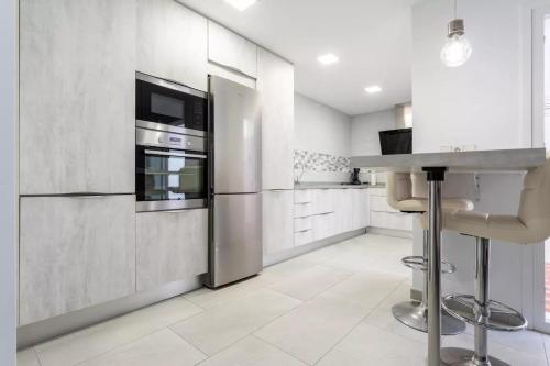 a kitchen with a stainless steel refrigerator and a counter at Casa capitán in Fuengirola