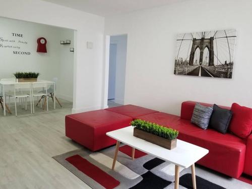 a living room with a red couch and a table at My lovely home in Miami 15 minutes from the Beach in Miami