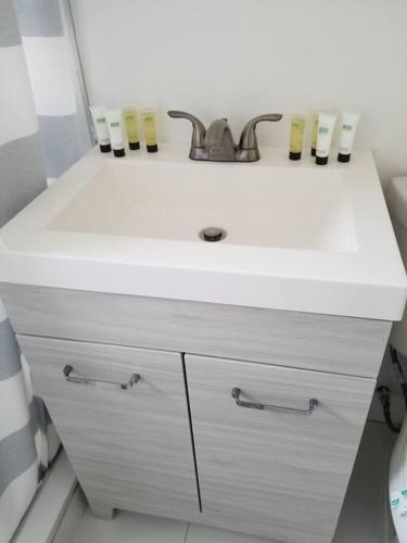 a bathroom with a sink and a white counter at My lovely home in Miami 15 minutes from the Beach in Miami