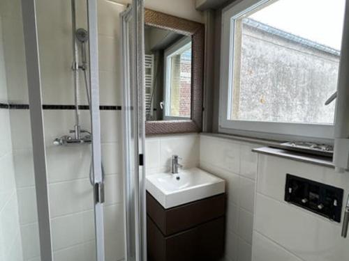 a white bathroom with a sink and a window at Villa Quend, 4 pièces, 6 personnes - FR-1-730-8 in Quend