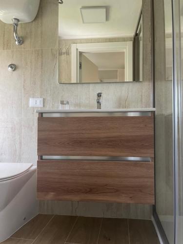 a bathroom with a sink and a mirror at SOPRAMARE BB - APPARTAMENTI in Rodi Garganico