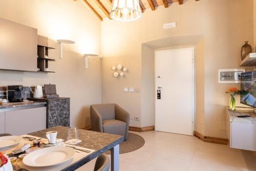 a kitchen and living room with a table and chairs at TENUTA FOGLIANI Resort & Natural Spa in Visciano