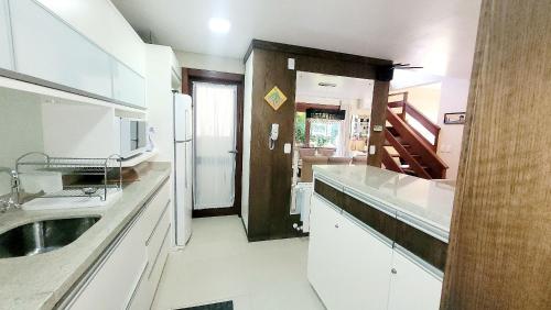 a kitchen with a sink and a counter top at casa próximo ao Centro in Gramado