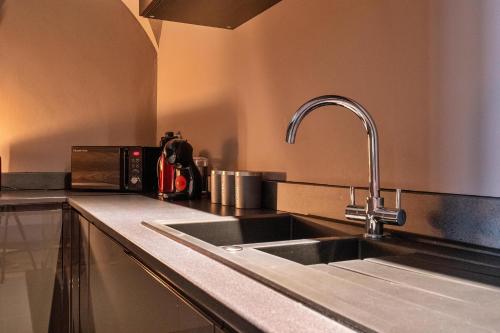 a kitchen counter with a sink and a sink at Finest Retreats - Hickleton Hall Estate in Doncaster