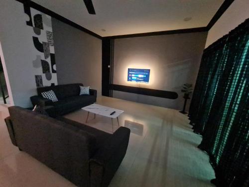 a living room with a couch and a table at Air-home M1 Simpang near Aulong Econsave, 4BR, 10pax, Netflix in Simpang