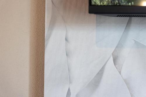 a close up of a window with white curtains at TENUTA FOGLIANI Resort & Natural Spa in Visciano