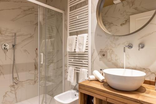 a bathroom with a sink and a glass shower at TENUTA FOGLIANI Resort & Natural Spa in Visciano
