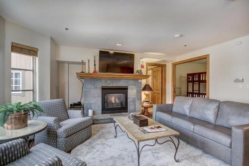a living room with a couch and a fireplace at 1BR Plus Den, Heart of Beaver Creek Village in Beaver Creek