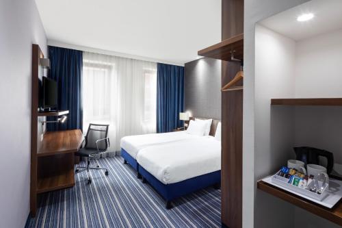 a hotel room with a bed and a desk at Holiday Inn Express The Hague - Parliament, an IHG Hotel in The Hague