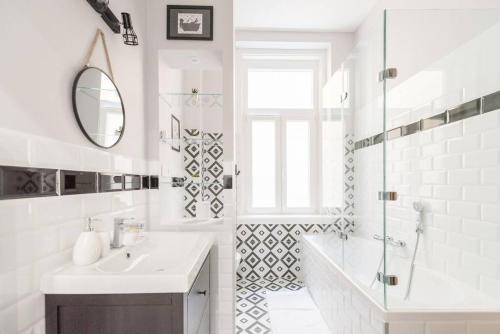a white bathroom with a sink and a shower at Venus Apartments - Market Hall I in Budapest