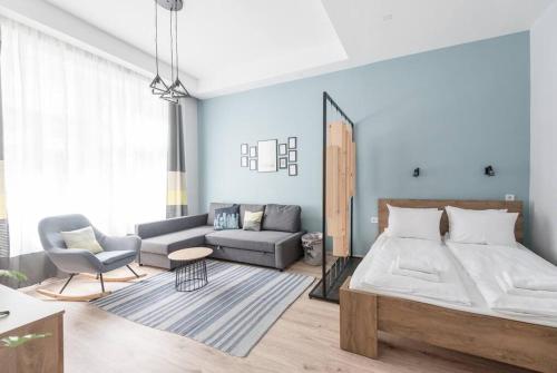 a bedroom with a bed and a couch at Venus Apartments - Market Hall I in Budapest
