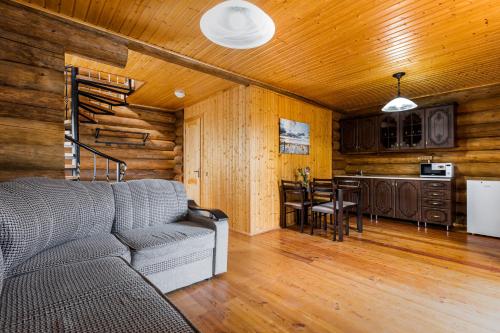 a living room with a couch and a kitchen at Hotel Paradise in Sukhum