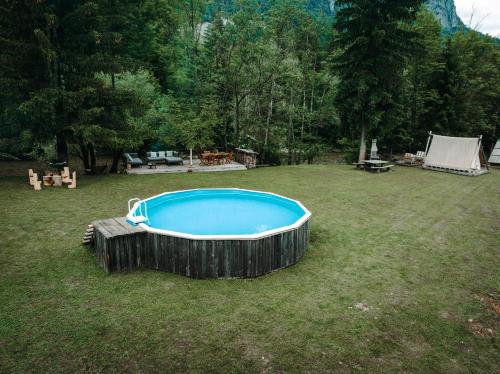 a hot tub in a yard with a tent at Goat's Paradise in Bohinj