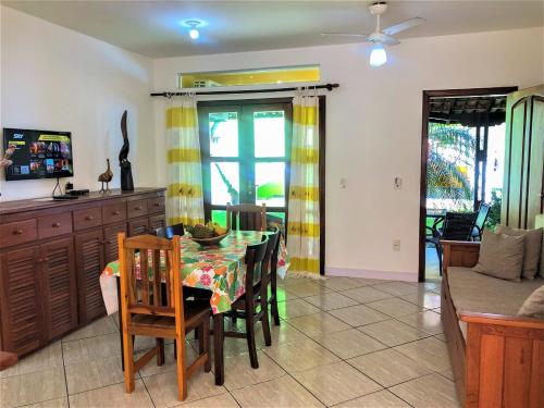 a kitchen and dining room with a table and chairs at Capoeira Village in Porto Seguro