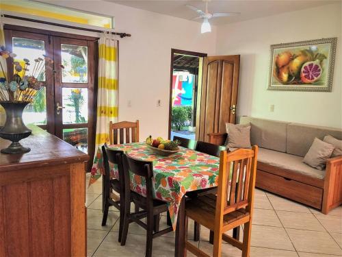a living room with a table and a couch at Capoeira Village in Porto Seguro
