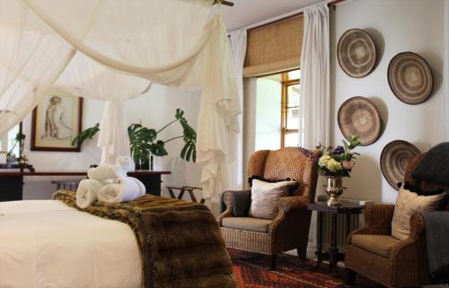 a bedroom with a bed with a teddy bear on it at Sionsberg Farmstay in Riversdale