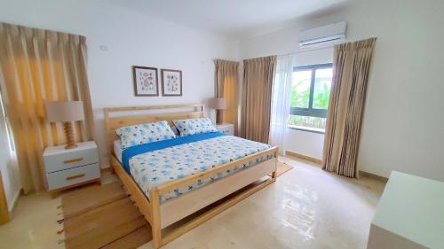 a bedroom with a bed and a window at Amar'e Aparthotel & Spa in Las Terrenas