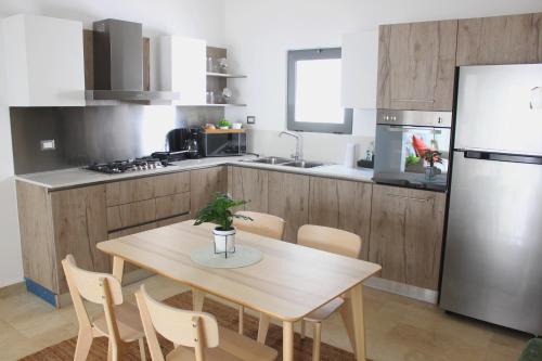 a kitchen with a table and chairs and a refrigerator at Amar'e Aparthotel & Spa in Las Terrenas