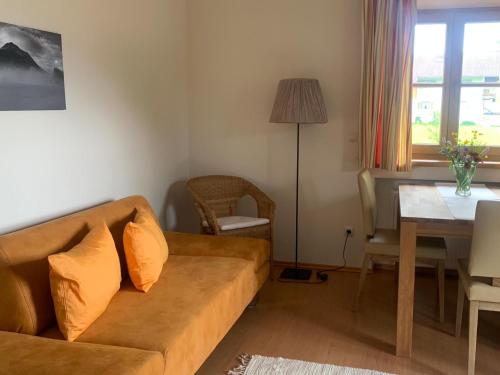 a living room with a couch and a table at Ferienwohnungen Monika Kloiber in Ruhpolding