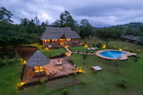 an aerial view of a house with a swimming pool at Karatu Tented Lodge in Karatu