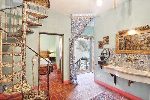 a bathroom with a staircase and a sink in a room at Il Sogno di Annalisa Relais in Laiatico
