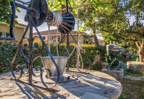 a metal object with ropes in a yard at Lofos Soilis in Tragaki