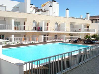 a large swimming pool in front of a building at Maré Cheia in Tavira