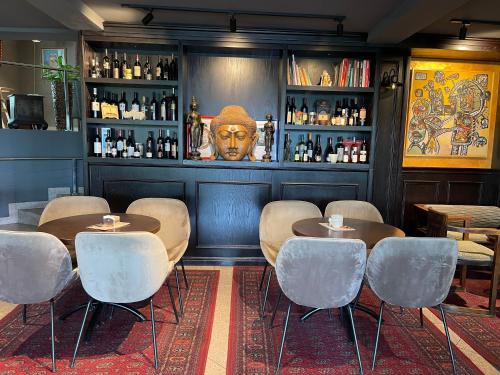 a restaurant with a bar with tables and chairs at Hotel Keto in Podgorica