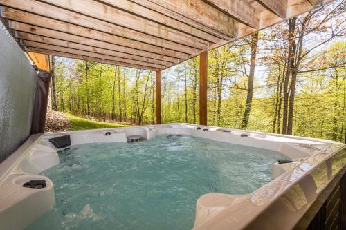 a hot tub in the middle of a forest at Family Sanity in McHenry