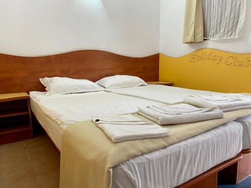 a hotel room with a bed with towels on it at Complex Holiday Neptun in Neptun