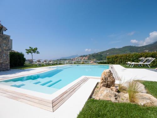 a swimming pool in a villa with mountains in the background at Agriturismo Terre degli Angeli in Pietra Ligure