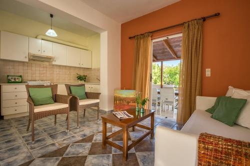 a living room with a couch and a kitchen at Lofos Soilis in Tragaki