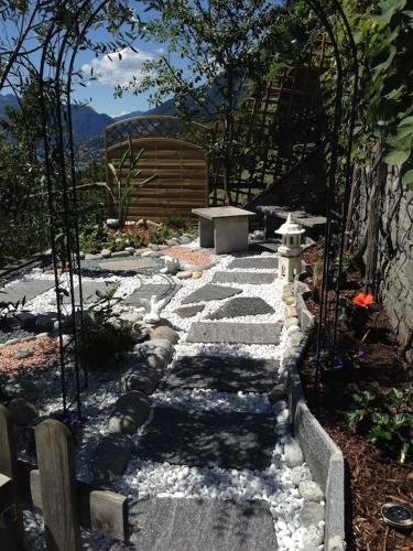 a stone pathway with a fire hydrant in a garden at Ferienhaus Patrizia with a fantastic view of Lake Maggiore and the pool in Gordola