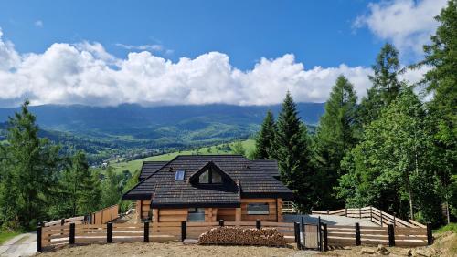 a log cabin in the middle of a mountain at Domki PRemium in Zawoja