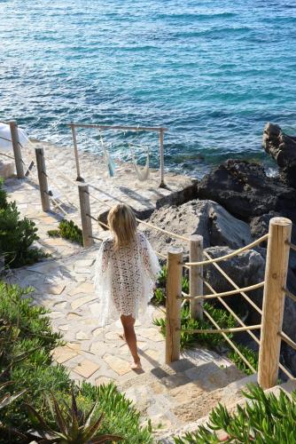 a little girl walking down the steps to the beach at Paradisso Beach Villas in Zakynthos Town