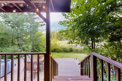 a wooden staircase leading to a porch with a view of a yard at Ruby Creek Retreat in Port Orchard